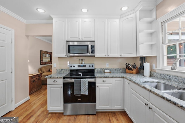 207 Saddle Mountain Rd SE, Rome, GA 30161 - kitchen with appliances with stainless steel finishes, a sink, ornamental molding, open shelves, and white cabinetry