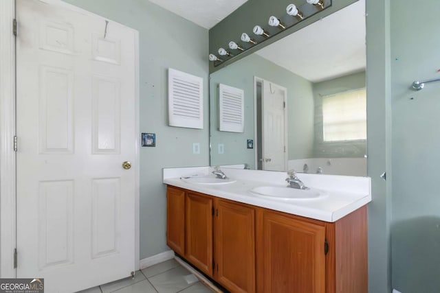 9550 Canvasback Ct, Jonesboro, GA 30238 - bathroom featuring double vanity, a bathtub, and tile patterned floors
