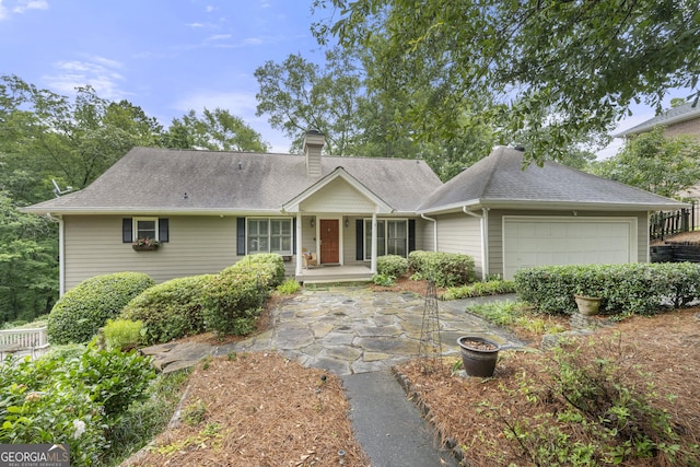 5065 Nesbit Ferry Ln, Atlanta, GA 30350 - view of front of house featuring an attached garage, a chimney, and a shingled roof