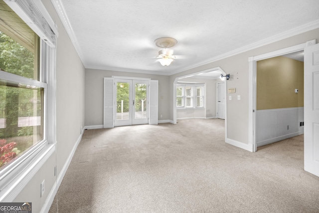 5065 Nesbit Ferry Ln, Atlanta, GA 30350 - unfurnished living room featuring ceiling fan, a textured ceiling, crown molding, light colored carpet, and french doors