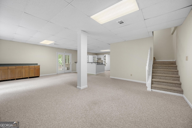 5065 Nesbit Ferry Ln, Atlanta, GA 30350 - below grade area featuring light colored carpet, a drop ceiling, and stairway