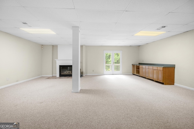 5065 Nesbit Ferry Ln, Atlanta, GA 30350 - unfurnished living room with light colored carpet, a fireplace with flush hearth, and a drop ceiling