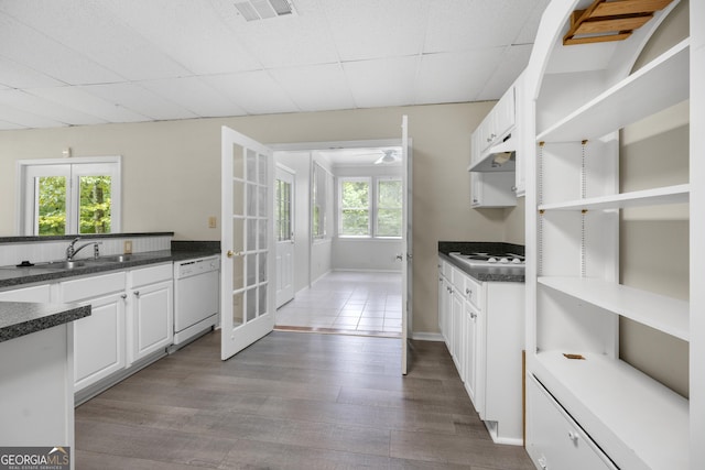 5065 Nesbit Ferry Ln, Atlanta, GA 30350 - kitchen featuring white appliances, french doors, dark countertops, and white cabinetry