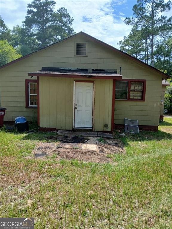 1263 Highland Ave, Macon, GA 31211 - rear view of house with a yard