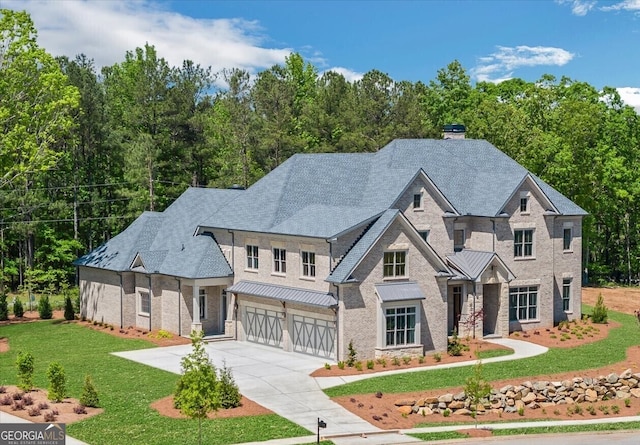 4927 Slaton Dr, Acworth, GA 30101 - view of front of house with an attached garage, concrete driveway, a front yard, a chimney, and brick siding