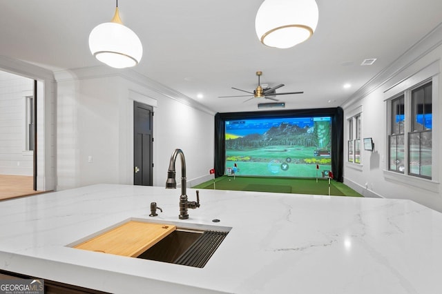 4927 Slaton Dr, Acworth, GA 30101 - kitchen featuring crown molding, golf simulator, light stone counters, ceiling fan, and decorative light fixtures