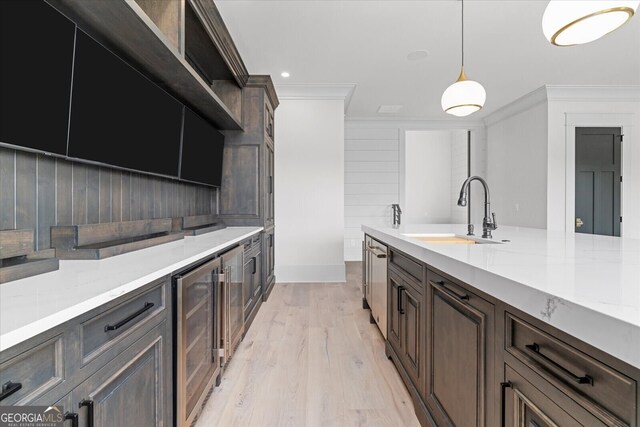 4927 Slaton Dr, Acworth, GA 30101 - kitchen featuring ornamental molding, wine cooler, pendant lighting, light wood-type flooring, and dark brown cabinets