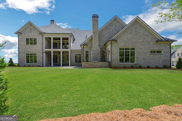 4927 Slaton Dr, Acworth, GA 30101 - rear view of property featuring a lawn, a balcony, a chimney, and brick siding