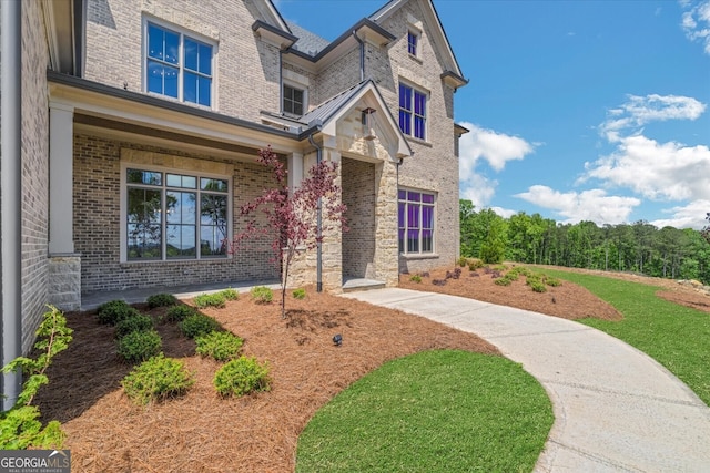 4927 Slaton Dr, Acworth, GA 30101 - view of front of home with brick siding, covered porch, stone siding, and a front lawn