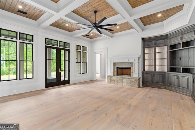 4927 Slaton Dr, Acworth, GA 30101 - unfurnished living room with coffered ceiling, light wood finished floors, a ceiling fan, a stone fireplace, and beam ceiling