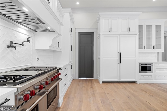 4927 Slaton Dr, Acworth, GA 30101 - kitchen featuring range with two ovens, extractor fan, light countertops, white cabinetry, and recessed lighting
