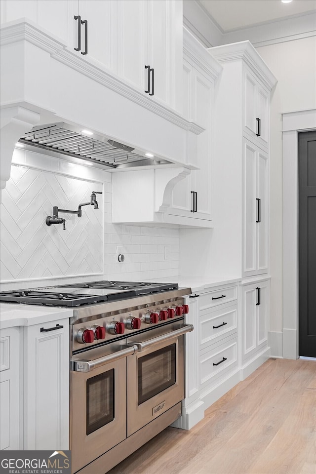 4927 Slaton Dr, Acworth, GA 30101 - kitchen with range with two ovens, backsplash, light countertops, and white cabinetry