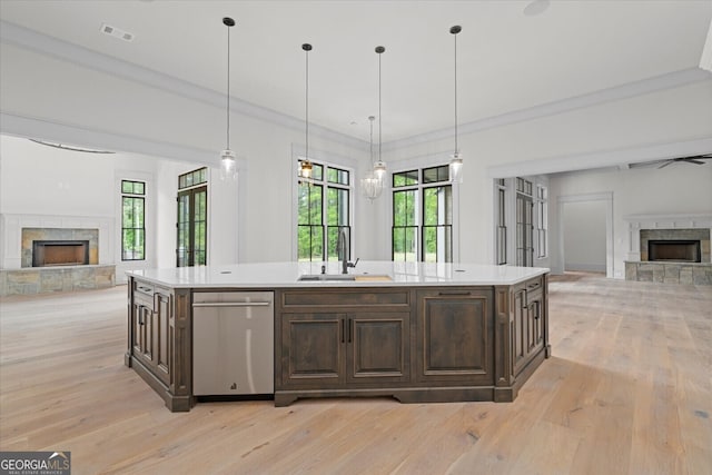 4927 Slaton Dr, Acworth, GA 30101 - kitchen with a fireplace with raised hearth, open floor plan, dishwasher, dark brown cabinetry, and crown molding