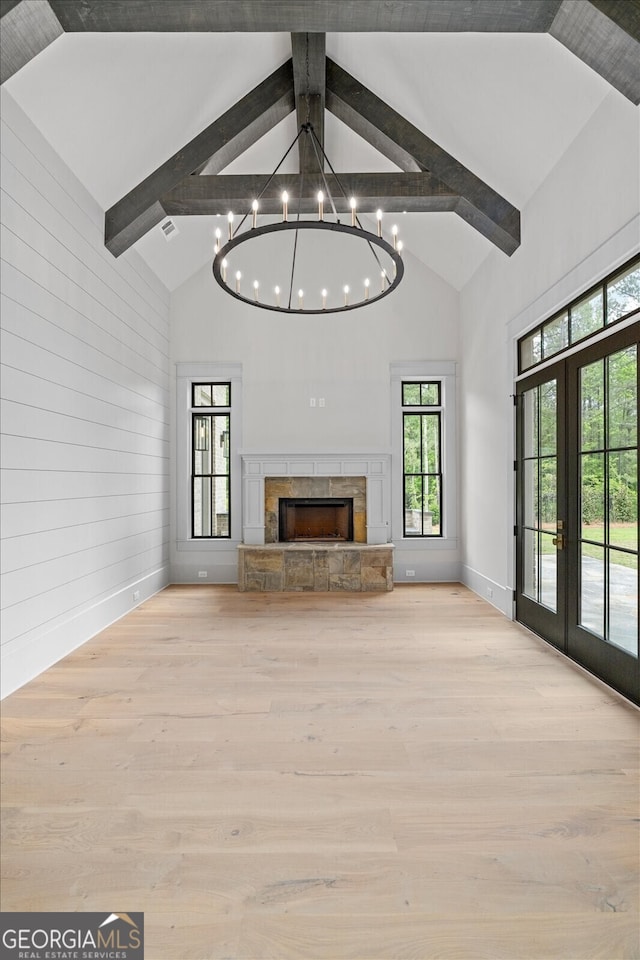 4927 Slaton Dr, Acworth, GA 30101 - unfurnished living room featuring beam ceiling, high vaulted ceiling, wood finished floors, a chandelier, and a fireplace
