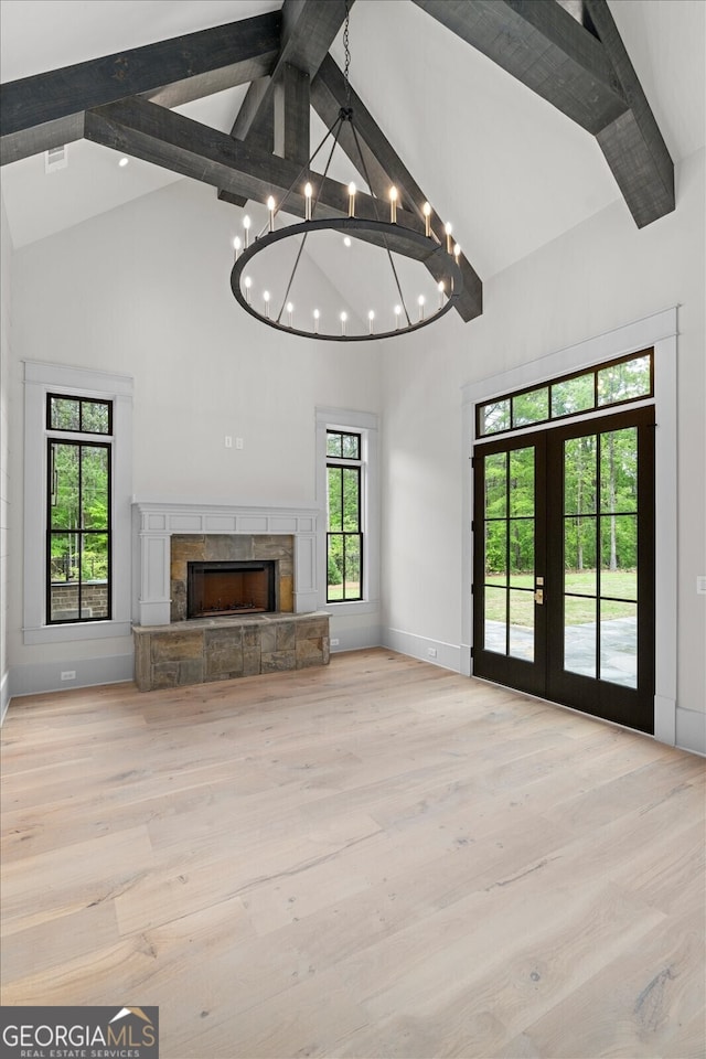 4927 Slaton Dr, Acworth, GA 30101 - unfurnished living room featuring high vaulted ceiling, beam ceiling, a fireplace, a chandelier, and wood finished floors