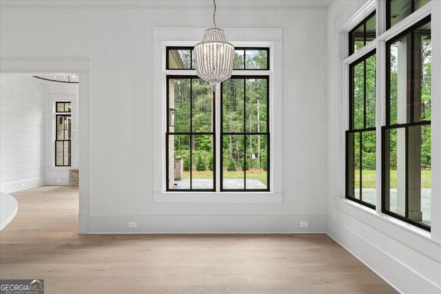 4927 Slaton Dr, Acworth, GA 30101 - unfurnished dining area with a chandelier and light wood-style flooring