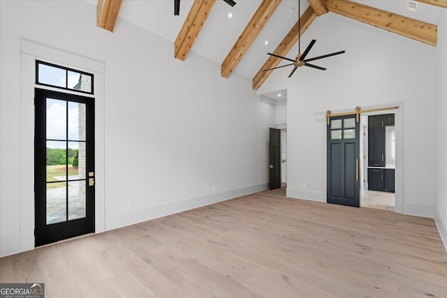 4927 Slaton Dr, Acworth, GA 30101 - unfurnished living room with a barn door, high vaulted ceiling, ceiling fan, wood finished floors, and beamed ceiling
