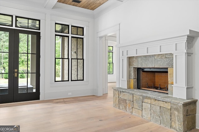 4927 Slaton Dr, Acworth, GA 30101 - doorway with french doors, light wood-style flooring, a wood ceiling with exposed beams, and a fireplace with raised hearth