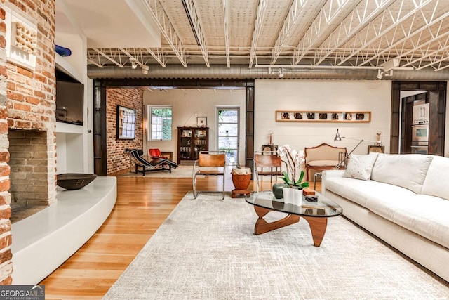 1933 Mclendon Ave NE Unit A, Atlanta, GA 30307 - living room with wood finished floors and brick wall