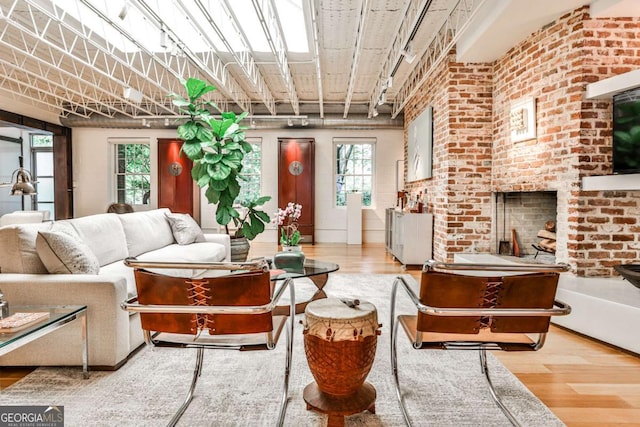1933 Mclendon Ave NE Unit A, Atlanta, GA 30307 - living area featuring wood finished floors, healthy amount of natural light, brick wall, and a fireplace