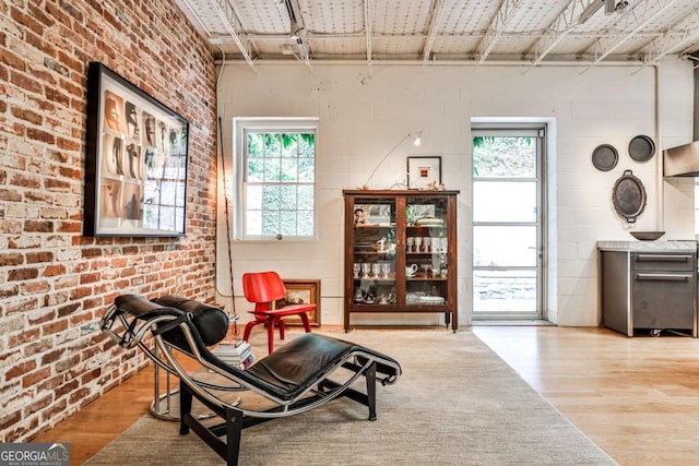 1933 Mclendon Ave NE Unit A, Atlanta, GA 30307 - living area featuring wood finished floors, healthy amount of natural light, and brick wall