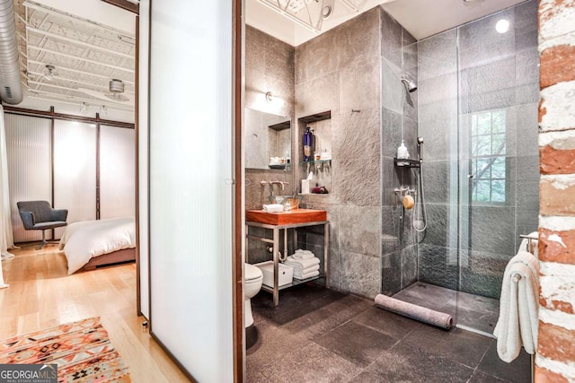 1933 Mclendon Ave NE Unit A, Atlanta, GA 30307 - ensuite bathroom featuring walk in shower, toilet, vanity, and tile walls