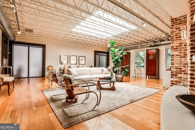 1933 Mclendon Ave NE Unit A, Atlanta, GA 30307 - living room featuring wood finished floors and brick wall