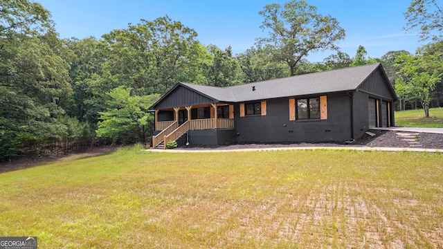 8129 S Giles Rd, Douglasville, GA 30135 - view of front of property with a front lawn, a porch, roof with shingles, and crawl space