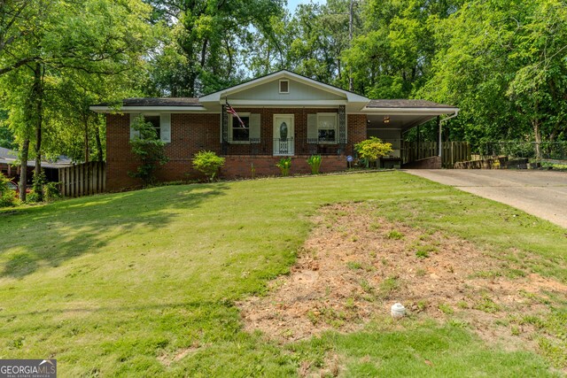 707 29th St, Phenix City, AL 36867 - ranch-style house with concrete driveway, brick siding, and a carport