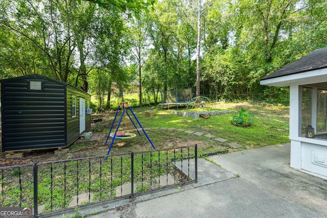 707 29th St, Phenix City, AL 36867 - view of yard with a trampoline, a patio area, view of scattered trees, a playground, and an outbuilding