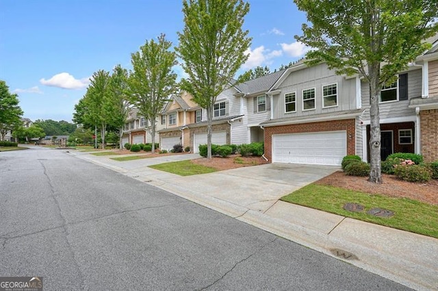411 Mountain View Ln, Woodstock, GA 30188 - townhome / multi-family property with an attached garage, concrete driveway, a residential view, board and batten siding, and brick siding