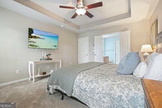 411 Mountain View Ln, Woodstock, GA 30188 - carpeted bedroom featuring a raised ceiling, baseboards, ensuite bath, and ceiling fan