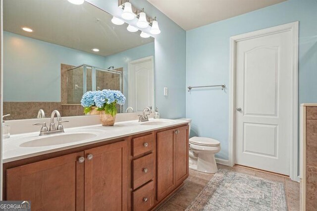 411 Mountain View Ln, Woodstock, GA 30188 - full bathroom featuring a stall shower, double vanity, toilet, and tile patterned floors