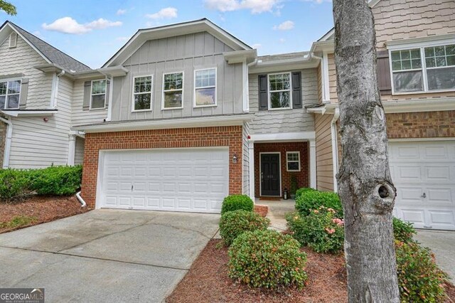 411 Mountain View Ln, Woodstock, GA 30188 - multi unit property with brick siding, driveway, an attached garage, and board and batten siding