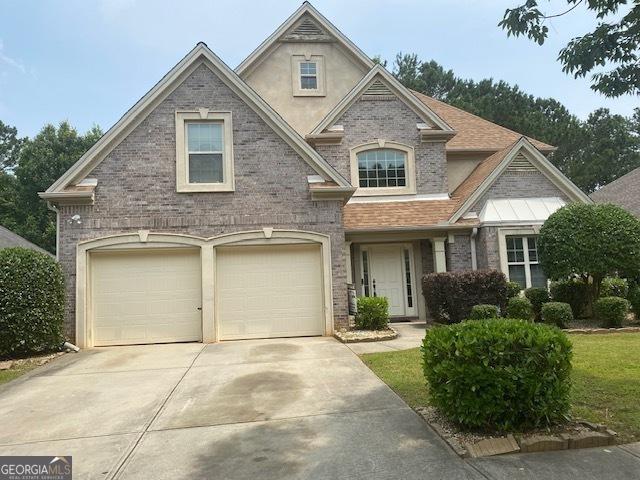 7981 Gossamer Dr, Fairburn, GA 30213 - view of front of house featuring a garage, driveway, and brick siding