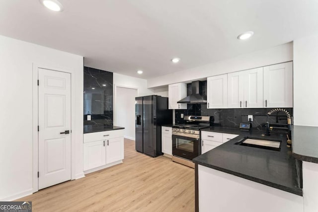 3878 Brookside Pkwy, Decatur, GA 30034 - kitchen with stainless steel range with gas cooktop, wall chimney exhaust hood, black refrigerator with ice dispenser, a sink, and light wood-style flooring