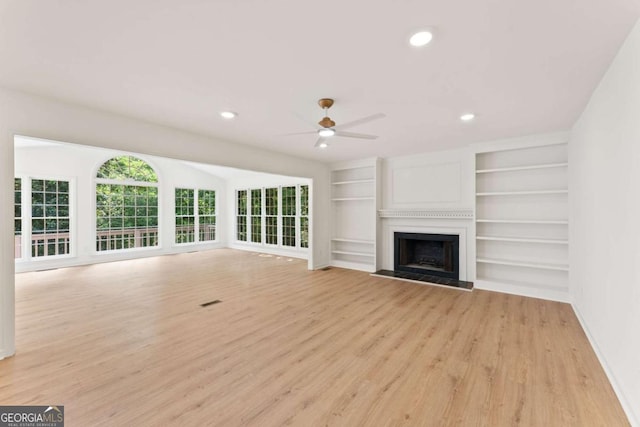 3878 Brookside Pkwy, Decatur, GA 30034 - unfurnished living room with light wood finished floors, a ceiling fan, a fireplace with raised hearth, baseboards, and recessed lighting