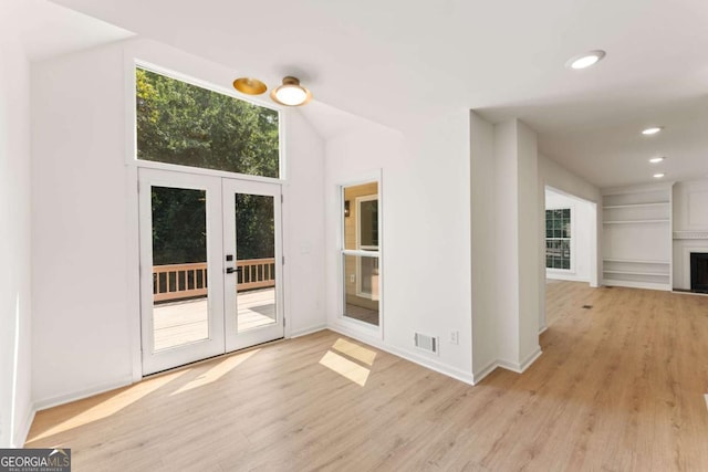 3878 Brookside Pkwy, Decatur, GA 30034 - empty room featuring french doors, light wood finished floors, recessed lighting, baseboards, and a fireplace