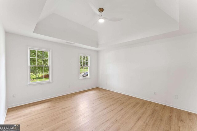3878 Brookside Pkwy, Decatur, GA 30034 - unfurnished room featuring a tray ceiling, healthy amount of natural light, light wood-style flooring, and a ceiling fan