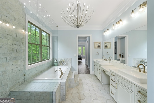 7519 Waterview Cv, Douglasville, GA 30135 - ensuite bathroom with healthy amount of natural light, a chandelier, double vanity, a garden tub, and ornamental molding