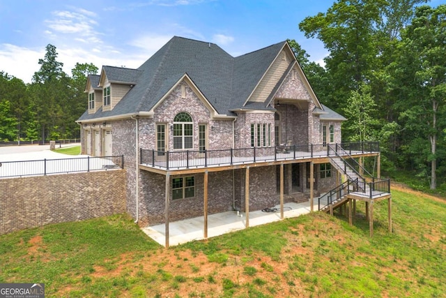 7519 Waterview Cv, Douglasville, GA 30135 - rear view of property with a wooden deck, stairs, brick siding, a lawn, and a patio area