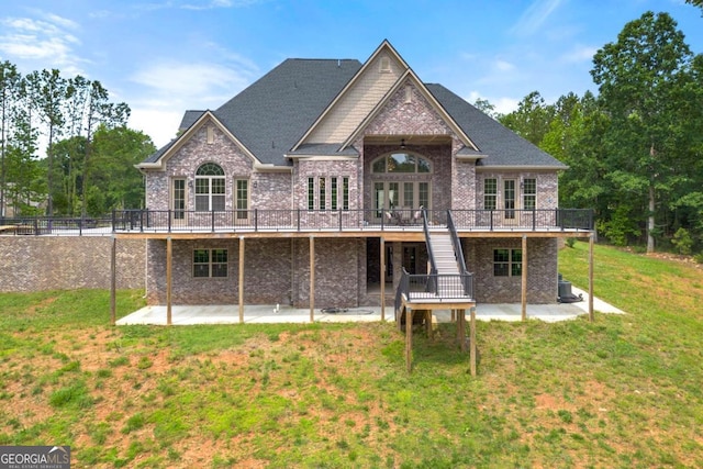 7519 Waterview Cv, Douglasville, GA 30135 - back of house with a patio, a wooden deck, brick siding, and a lawn