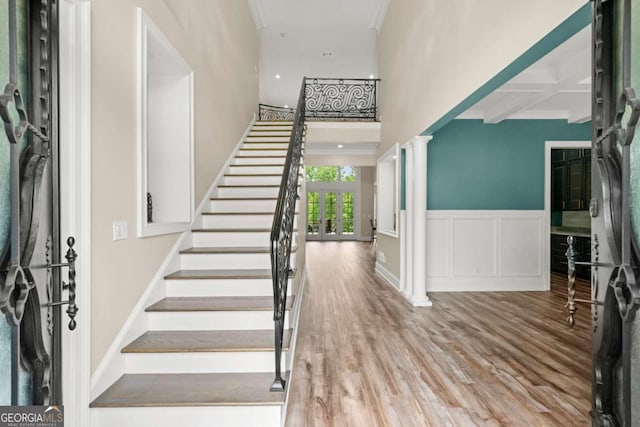 7519 Waterview Cv, Douglasville, GA 30135 - foyer featuring stairway, wood finished floors, a high ceiling, ornamental molding, and decorative columns