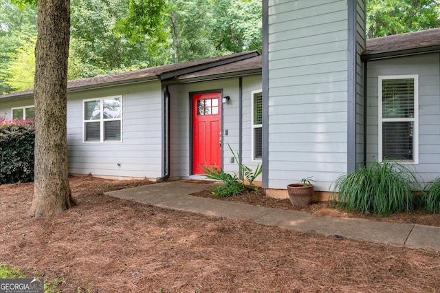 609 Hearth Pl, Lawrenceville, GA 30043 - view of exterior entry featuring a chimney and roof with shingles