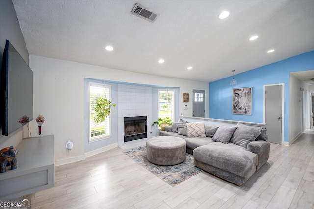 609 Hearth Pl, Lawrenceville, GA 30043 - living room featuring baseboards, light wood-style floors, a fireplace, recessed lighting, and lofted ceiling