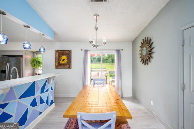 609 Hearth Pl, Lawrenceville, GA 30043 - dining space with light wood-style floors, a chandelier, and baseboards