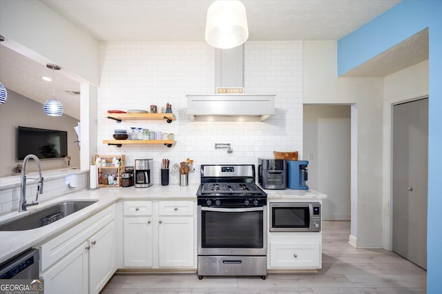 609 Hearth Pl, Lawrenceville, GA 30043 - kitchen featuring appliances with stainless steel finishes, a sink, tasteful backsplash, and white cabinets