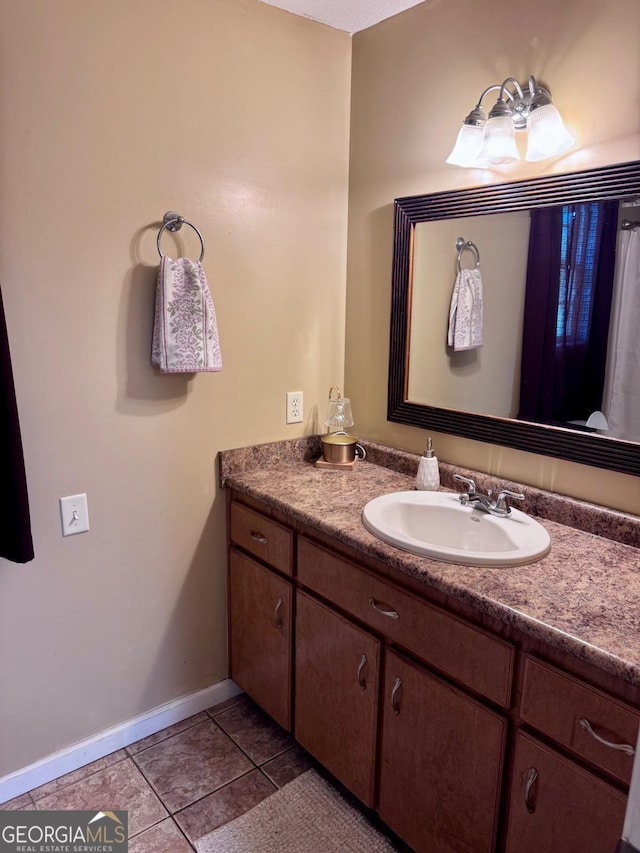 309 Ralph Wommack Rd, Hazlehurst, GA 31539 - bathroom with vanity, tile patterned flooring, and baseboards