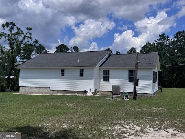 309 Ralph Wommack Rd, Hazlehurst, GA 31539 - back of property featuring central AC, a yard, and a shingled roof