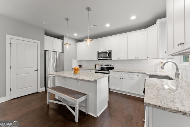 79 Brynbrooke Ct, Dawsonville, GA 30534 - kitchen with appliances with stainless steel finishes, a sink, white cabinetry, decorative backsplash, and recessed lighting